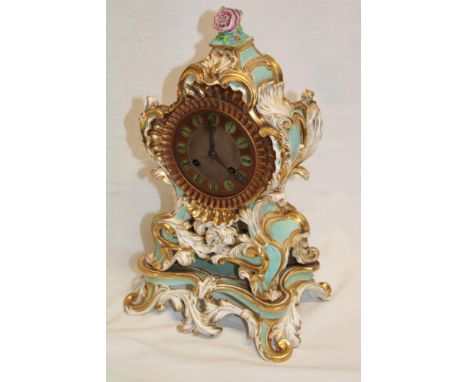 A 19th Century French mantel clock with chiming movement and brass circular dial in china scroll decorated case 13 1/2" high