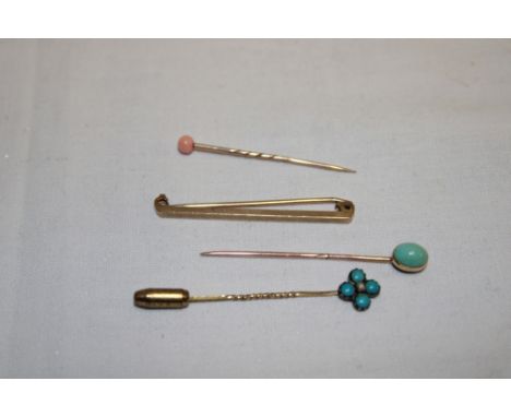 A 9ct gold bar brooch and three various stick pins