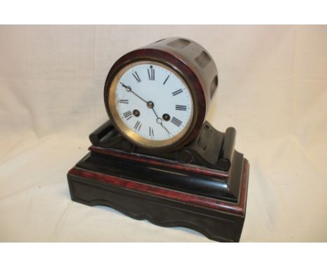 A Victorian mantel clock with circular enamel dial in black slate and red marble domed case (af)