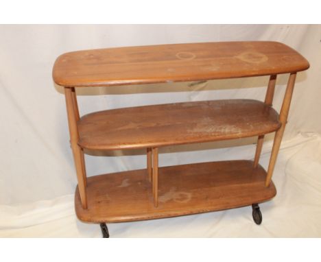 A 1960's Ercol light elm room divider/book shelves on castors, 30" high
