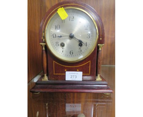 A SMALL ARCHED TOP MANTLE CLOCK 
