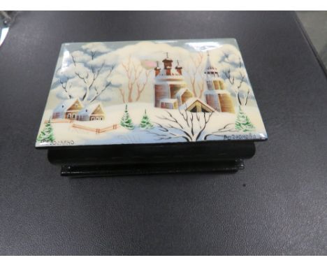 A MODERN RUSSIAN TYPE BLACK LACQUER BOX WITH HAND PAINTED WINTER SCENE SIGNED LOWER RIGHT TOGETHER WITH A HALCYON DAYS ENAMEL