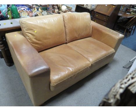 A TAN LEATHER TWO SEATER SOFA