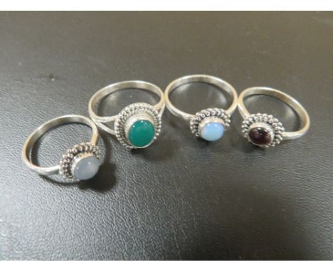 A COLLECTION OF FOUR 925 SILVER GEMSTONE DRESS RINGS TO INC JADE, GARNET ETC 