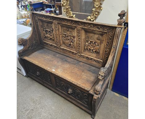 HEAVILY CARVED OAK DUTCH STYLE MONKS BENCH/SETTLE WITH LION HANDLES CARVED BUST FINIALS AND TRIPLE CARVED PANELLED BACK &amp;