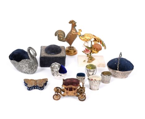 A collection of silver, metalware, electroplated and gilt- metal pin cushions, various designs including: four of basket form