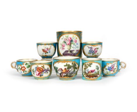 Five Vincennes and Sèvres small cups  c.1754-61, variously painted with panels of flowers within gilt foliate borders on a bl