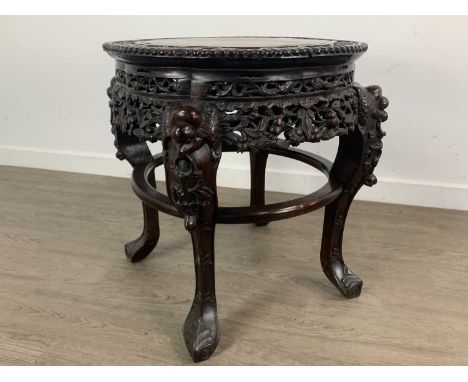 CHINESE HARDWOOD TABLE, 20TH CENTURY the top inset with rouge marble panel, with pierced floral and scroll detail, on cabriol