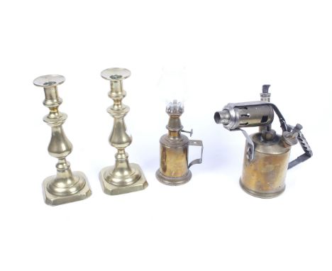 A group of vintage brass items. including a pair of brass candlesticks, an oil lamp and a Chas Twigg & Co. Ltd blow torch. Ma