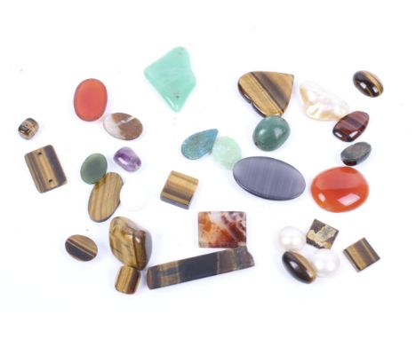 A collection of semi-precious stones. Including agate, tigers eye and jade, various shapes and sizes
