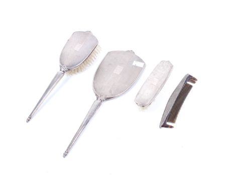 A silver mounted four piece dressing table set. Comprising a hand mirror, hair brush, cob and clothes brush, each engine-turn