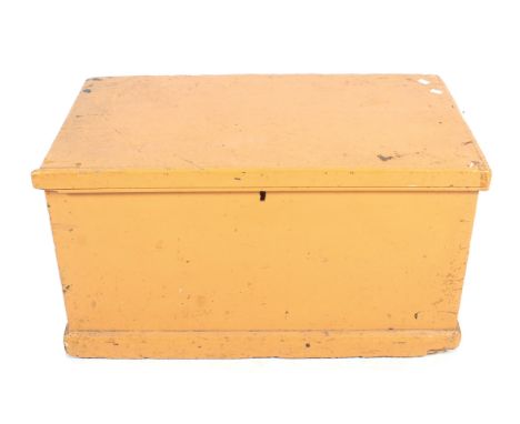 A painted pine trunk. Painted orange on the outside with a wrought iron swing handle at each end. L84cm x D47cm x H46cm