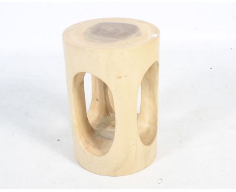 A turned hardwood trunk stool. Pierced through with large ovals, approx. 45.5cm high overall, 30cm diameter