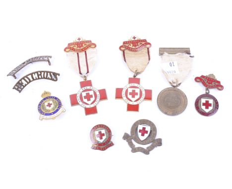 Nine vintage red cross medals and pin badges. The majority marked 'Ethel Sloper' to the backs