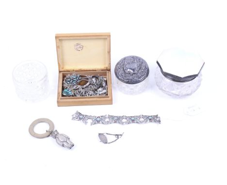 A small collection of silver and white metal jewellery and two silver mounted dressing table bottles. The jewellery including