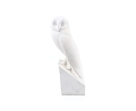 A 20th century carved white stone model of a barn owl perched on a sloping square base. 40cm high overall