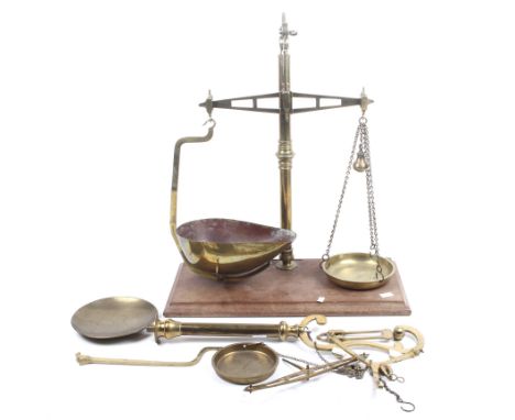 A set of vintage Bartlett Bristol brass balance scales and a part set. Raised on a mahogany rectangular base. H59cm