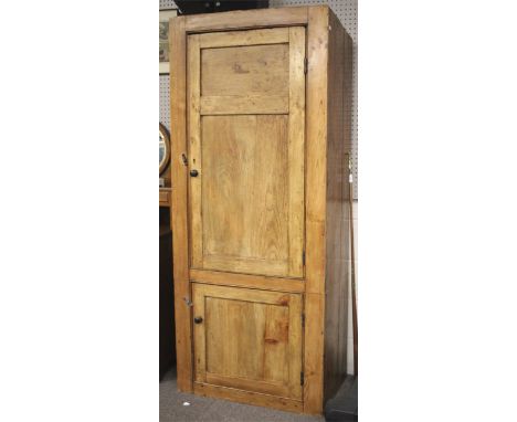 A vintage stripped pine two piece cupboard. With a sloping top, each part having a single door, opening to reveal shelves. L8