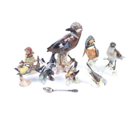 A collection of eight assorted Goebel figures. Including seven china birds and a girl on a fence, stamped 1938 figure, etc. M