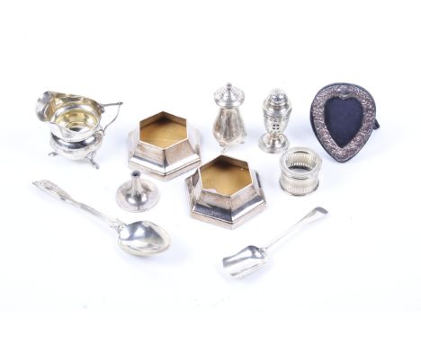 A small collection of silver including a silver round cream jug. With an angular scroll handle, a moulded rim and three hoof 