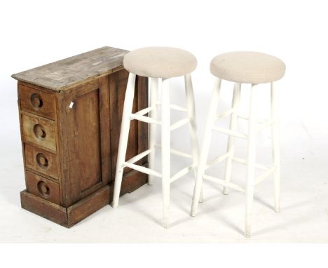 A pair of 20th contemporary bar stools and a set of drawers. Consisting of white painted frame with upholstered button seat, 