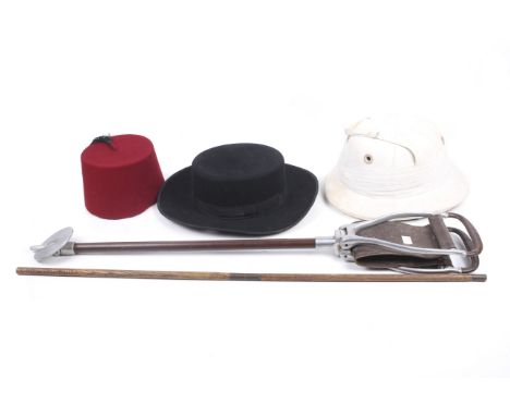Three hats, a shooting stick and a walking stick. The hats including a black suede broad rimmed hat, a Herbert Johnson safari