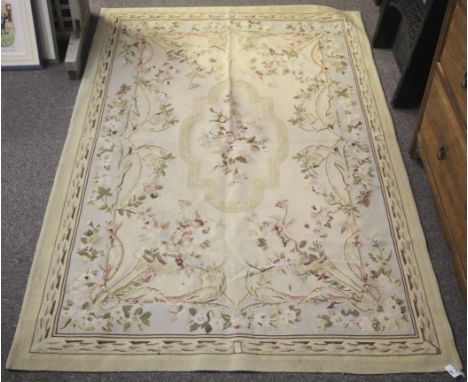 An early 20th century tapestry wall hanging. A border floral swags and rope tassel spandrels, central medallion of a flowers.