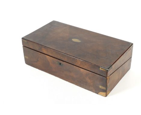 A 19th century mahogany veneered brass bound writing slope. The fitted interior having an unusual glass inkwell, mauve velvet