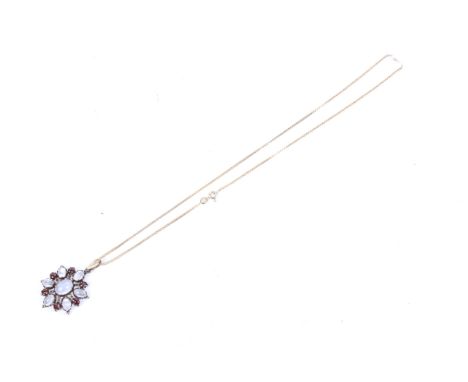 A 9ct gold, moonstone and garnet cluster pendant. Hung from a vintage Italian 9ct gold box chain, chain 2.1g