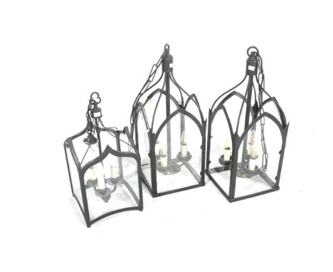 A pair of contemporary hall lanterns and a smaller similar lantern. Each having three electric light fittings and glass cover