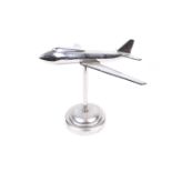 Chrome desk model of a Boeing 747 Jumbo jet plane in flight.