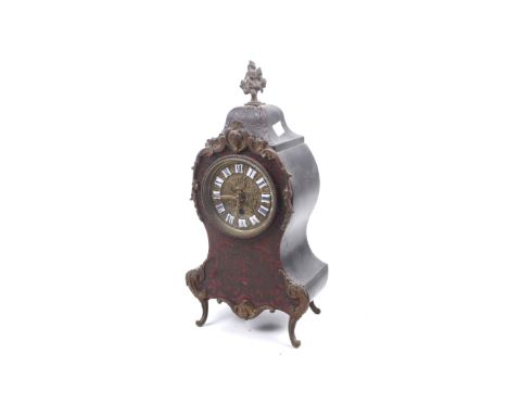 An ormolu mounted boulle work mantel clock case. Of waisted balloon form, a cast floral finial. Brass embossed dial with whit