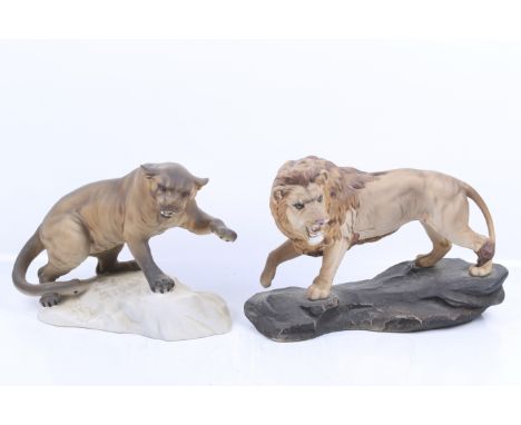 Two vintage Beswick ceramic animal figures. Including a 'Lion on Rock' and a 'Puma on Rock' (#1702). Max. H21cm
