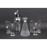 A mid-century glass cocktail set and a soda syphon.