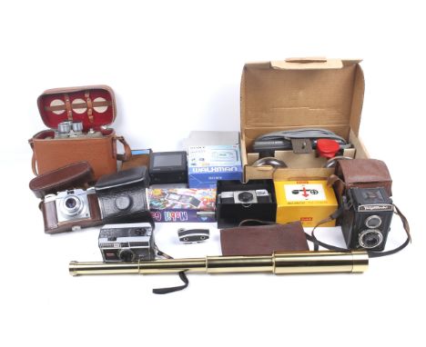 A collection of mixed vintage cameras and portable electronic items. Including a Sony Walkman boxed, a Casio LCD TV-7500, etc