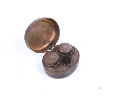 An oval Victorian leather bound travelling inkwell. Lid opening to reveal engraved twin copper inkwells with original glass b