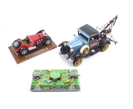 Three automobile related models. Consisting of a tow truck; a Burago Mercedes-Benz SSK (1928) and a clock work tin plate toy 