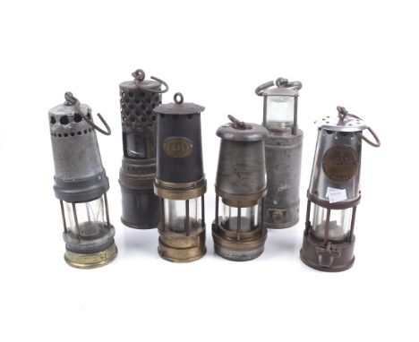 A collection of six assorted vintage miners lamps. Including a 'Patterson Lamps Ltd' no. 221 and 'The Wolf, Radiator Lamp', e