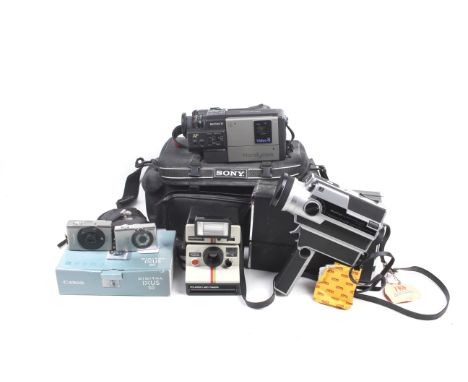A collection of assorted film and digital cameras. Including a Polaroid Land 1000 with flash attachment and a Canon IXUS 50 b