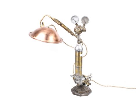 A scratch built 'Steam Punk' table lamp. Twin gauges above brass taps with a copper shade. H55cm