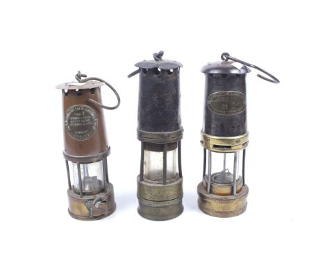 Three vintage brass miners lamps. Including E. Thomas & Williams Ltd, Cambrian Type No.54, Eccles Type 6, etc. Max. H27cm 
