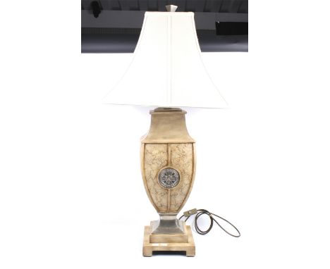 Large contemporary table lamp. Inset with metal medallions, mounted on a square tiered base, having a cream shade. H70cm (exc
