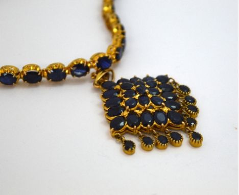 A SAPPHIRE NECKLACE, comprising a large kite shape pendant with three levels of oval shape sapphires with a fringe, to a sapp