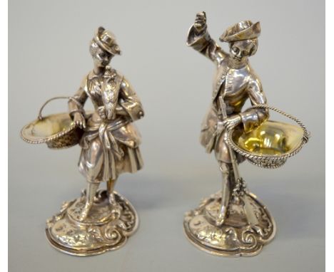 A PAIR OF VICTORIAN SILVER SALTS, each well cast as a gentleman and lady dressed in clothes out on a hunt, the 18th Century g