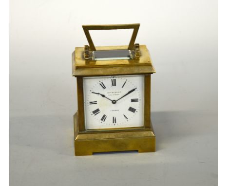 A BRASS MANTEL CLOCK, enamel dial with Roman numerals marked Geo. E. Blackie, 392 Strand, London, rectangular case on plinth 