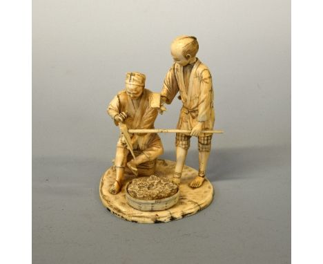 A JAPANESE IVORY OKIMONO, Meiji period, two figures mending a farming tool, marks to base, height approximately 15.5cm