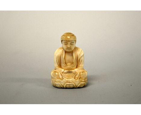 A JAPANESE IVORY NETSUKE, carved as a Buddha , signed to base