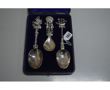 THREE SILVER CASED SPOONS, to include caddy spoon with Adam and Eve figural finial and engraved fruit bowl and nautical scene