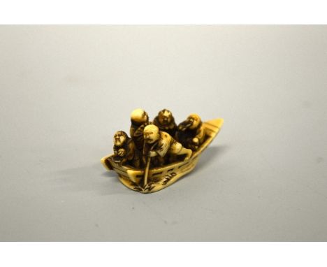 A JAPANESE IVORY NETSUKE, of five men in a boat, signed to base