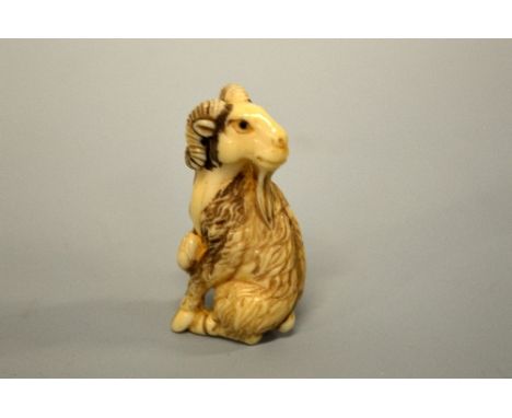 A JAPANESE IVORY NETSUKE, carved in the form of a Mountain Goat, signed to base 